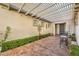 Covered patio with seating area, lush greenery, and a pergola at 4129 Cackling Goose Dr, North Las Vegas, NV 89084