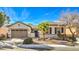 Single-story home with a two-car garage and desert landscaping at 4129 Cackling Goose Dr, North Las Vegas, NV 89084