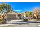 Single-story home with a two-car garage and mature trees at 4129 Cackling Goose Dr, North Las Vegas, NV 89084