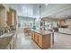 Kitchen with island, granite counters, and view into living room at 4129 Cackling Goose Dr, North Las Vegas, NV 89084