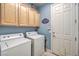 Laundry room with washer, dryer, and ample cabinet storage at 4129 Cackling Goose Dr, North Las Vegas, NV 89084