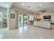 Bright living room with tile floors, fireplace and sliding glass doors to backyard at 4129 Cackling Goose Dr, North Las Vegas, NV 89084