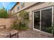 Charming backyard patio area with lush landscaping and a sliding glass door at 5372 Silver Branch Ave, Las Vegas, NV 89118