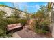 Backyard patio area with a comfortable couch and surrounding greenery at 5372 Silver Branch Ave, Las Vegas, NV 89118