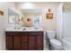 Bathroom featuring a double vanity with dark wood cabinets and a shower-tub combination at 5372 Silver Branch Ave, Las Vegas, NV 89118