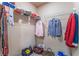 Walk-in closet with wire shelving and a variety of clothing items at 5372 Silver Branch Ave, Las Vegas, NV 89118