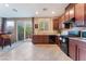 Modern kitchen with dark wood cabinets, granite countertops, and stainless steel appliances at 5372 Silver Branch Ave, Las Vegas, NV 89118