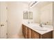 Bathroom with double sinks and a large mirror at 6547 Velvet Silk St, North Las Vegas, NV 89084