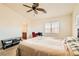 Bright bedroom with ensuite bathroom access, ceiling fan, and window coverings at 6547 Velvet Silk St, North Las Vegas, NV 89084