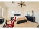 Bright bedroom with king bed, ceiling fan, and built-in workspace at 6547 Velvet Silk St, North Las Vegas, NV 89084