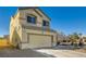 Tan two-story house with a two-car garage and desert landscaping at 6547 Velvet Silk St, North Las Vegas, NV 89084