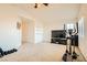 Spacious home gym with elliptical and TV at 6547 Velvet Silk St, North Las Vegas, NV 89084