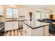 Updated kitchen featuring white cabinets, granite counters, and wood-look floors at 6547 Velvet Silk St, North Las Vegas, NV 89084