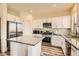 Modern kitchen with stainless steel appliances and an island at 6547 Velvet Silk St, North Las Vegas, NV 89084