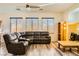 Relaxing living room featuring a large sectional sofa and hardwood floors at 6547 Velvet Silk St, North Las Vegas, NV 89084