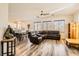 Living room with dark leather sectional sofa and wood-look floors at 6547 Velvet Silk St, North Las Vegas, NV 89084