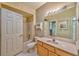 Charming bathroom with a tub and shower, classic vanity, bright lighting, and tiled floors at 7151 S Durango Dr # 214, Las Vegas, NV 89113