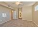 Comfortable bedroom with soft carpet, a ceiling fan, and easy access to the bathroom at 7151 S Durango Dr # 214, Las Vegas, NV 89113