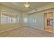 Bedroom with view into kitchen, ceiling fan, and carpeted floors at 7151 S Durango Dr # 214, Las Vegas, NV 89113