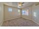 Cozy bedroom with neutral carpet, a ceiling fan, and plenty of natural light from the window at 7151 S Durango Dr # 214, Las Vegas, NV 89113