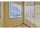 Bright entryway with tile flooring, window blinds, and white door at 7151 S Durango Dr # 214, Las Vegas, NV 89113