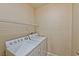 Functional laundry room with washer, dryer, and wire shelving for storage at 7151 S Durango Dr # 214, Las Vegas, NV 89113