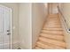 Elegant wooden staircase adjacent to the front door, providing access to the upper levels of the home at 7151 S Durango Dr # 214, Las Vegas, NV 89113