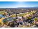 Beautiful aerial view of a home in a golf course community with mature trees, ponds, and mountain views at 8713 Litchfield Ave, Las Vegas, NV 89134