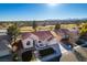 Aerial view of landscaped home with tile roof, lake, and golf course at 8713 Litchfield Ave, Las Vegas, NV 89134