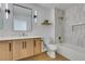 Modern bathroom features wood vanity with marble countertops, white tile shower, and updated fixtures at 8713 Litchfield Ave, Las Vegas, NV 89134