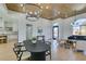 Open concept dining room with a black table and modern chandelier at 8713 Litchfield Ave, Las Vegas, NV 89134