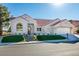 Single-story home with a red tile roof, landscaping, and a two-car garage at 8713 Litchfield Ave, Las Vegas, NV 89134