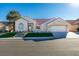 One-story house with attractive landscaping and a two-car garage at 8713 Litchfield Ave, Las Vegas, NV 89134