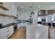 A contemporary kitchen featuring white cabinetry, stainless steel appliances, and a large marble island with bar seating at 8713 Litchfield Ave, Las Vegas, NV 89134