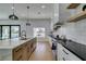 Spacious kitchen with white and wood cabinets, gas range and marble countertops at 8713 Litchfield Ave, Las Vegas, NV 89134