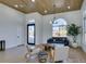 Light-filled living room with arched window, hardwood floors, and stylish seating at 8713 Litchfield Ave, Las Vegas, NV 89134