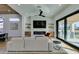 Stylish living room featuring an electric fireplace, a flat screen TV and a glass slider to the patio at 8713 Litchfield Ave, Las Vegas, NV 89134