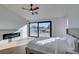 A bright main bedroom with a ceiling fan, an electric fireplace, and large windows with a view at 8713 Litchfield Ave, Las Vegas, NV 89134