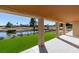 Covered patio with view of golf course, green grass, a lake, and desert landscaping at 8713 Litchfield Ave, Las Vegas, NV 89134