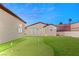 Enjoy outdoor living with a putting green in this spacious backyard of the home at 1725 Bannie Ave, Las Vegas, NV 89102