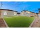 Spacious backyard featuring putting greens and views of the home's modern architecture at 1725 Bannie Ave, Las Vegas, NV 89102