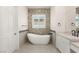 Bright bathroom featuring a sleek soaking tub and dual sink vanities at 1725 Bannie Ave, Las Vegas, NV 89102