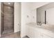 Bright bathroom featuring a tiled walk-in shower and a vanity with a stone countertop at 1725 Bannie Ave, Las Vegas, NV 89102