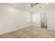 Carpeted bedroom featuring a modern ceiling fan and an ensuite bathroom with tile floors at 1725 Bannie Ave, Las Vegas, NV 89102