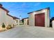 View of the home's side and garage, featuring manicured landscaping, lighting, and a glimpse of the Stratosphere at 1725 Bannie Ave, Las Vegas, NV 89102