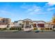 A house exterior with manicured landscaping, secured iron gate, and a paved driveway, showcasing a grand entrance at 1725 Bannie Ave, Las Vegas, NV 89102