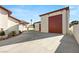 Side angle of the garage and home exterior with red garage door at 1725 Bannie Ave, Las Vegas, NV 89102