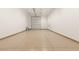 An empty spacious garage with an overhead door and epoxy flooring at 1725 Bannie Ave, Las Vegas, NV 89102