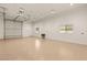 Spacious garage with an epoxy floor, bright lighting, and an automated door for convenient parking and storage at 1725 Bannie Ave, Las Vegas, NV 89102