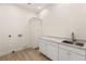 Laundry room with modern cabinets, stone countertops, and stainless-steel sink at 1725 Bannie Ave, Las Vegas, NV 89102